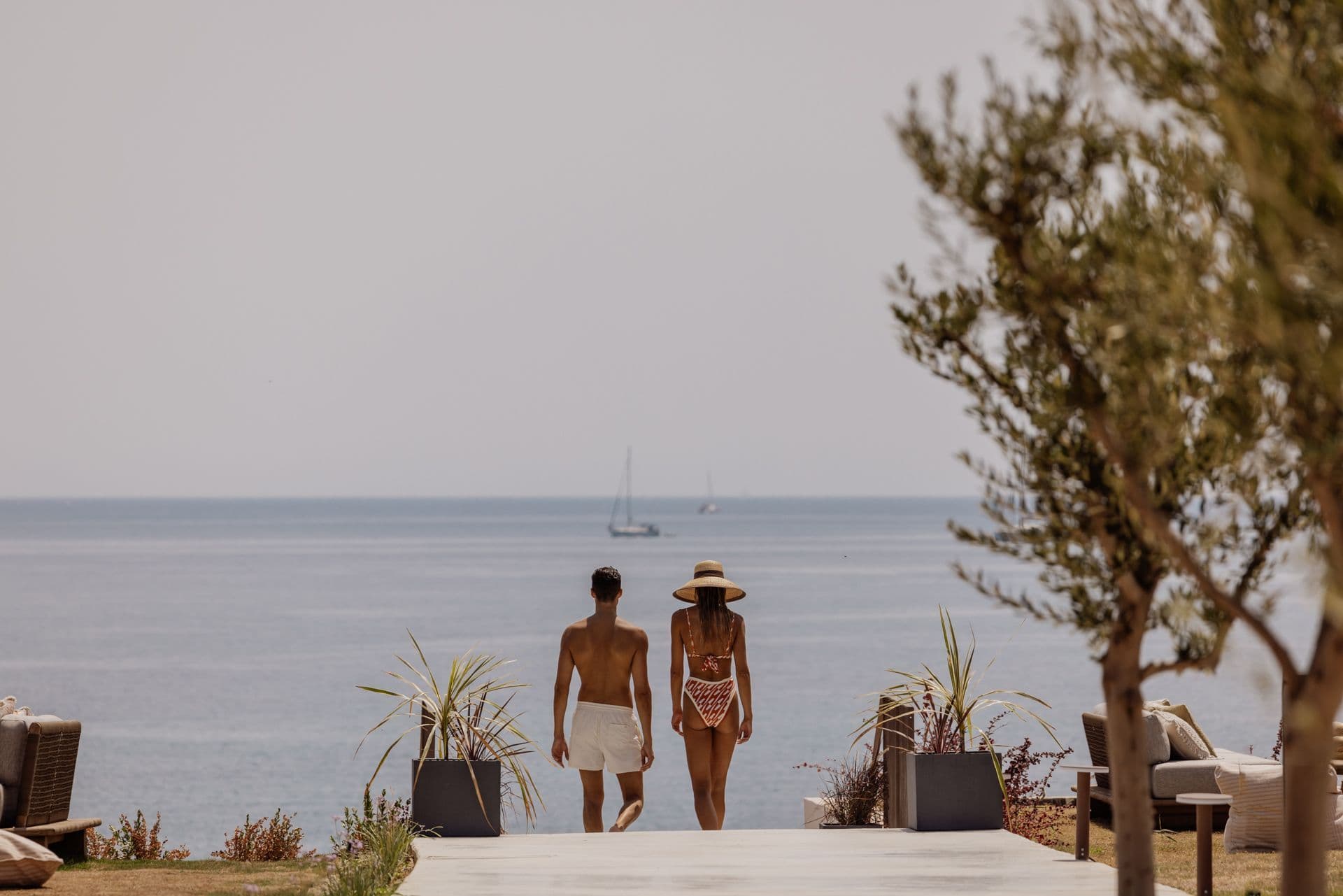 Couple making their way down to sea for a sailing trip around the island, one of the top Corfu excursions to experience. 
